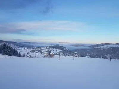 a snowy slope with a view of a mountain at Hotel Sunce Vlašić in Vlasic