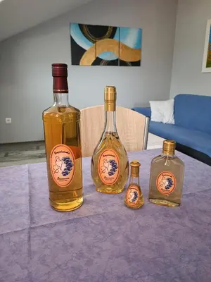 three bottles of whisky sitting on a purple table at Apartmani Janjic in Banja Luka