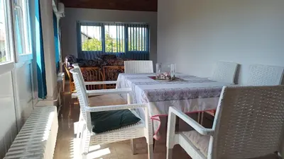 a dining room with a table and some chairs at Guesthouse Trikic in Drvar