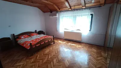 a bedroom with a bed and a large window at Guesthouse Trikic in Drvar