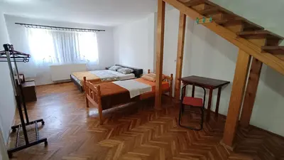 a room with two beds and a table in it at Guesthouse Trikic in Drvar