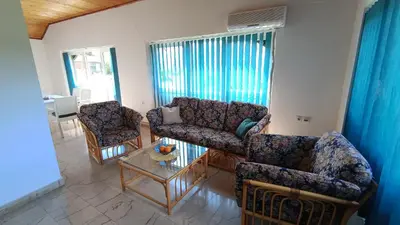 a living room with two couches and a table at Guesthouse Trikic in Drvar