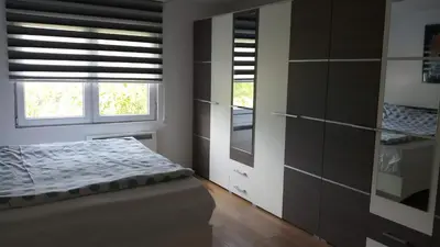 a bedroom with a bed and a window at Vikend kuća Careva Ćuprija-apartman in Olovo