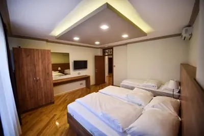 a large bedroom with two beds and a sink at Apartman Natalija Banja Luka in Banja Luka
