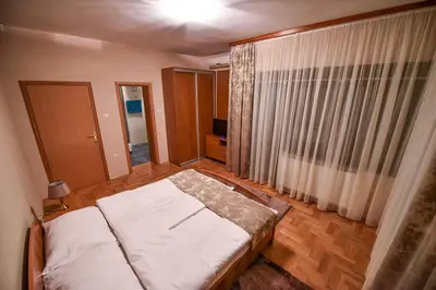 a bedroom with a bed and a large window at Apartman Natalija Banja Luka in Banja Luka