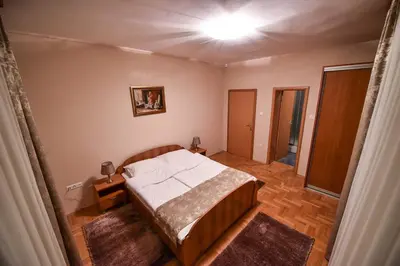 a bedroom with a bed and a light on the ceiling at Apartman Natalija Banja Luka in Banja Luka