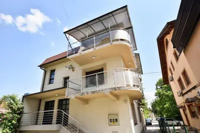 a building with a balcony on the side of it at Apartman Natalija Banja Luka in Banja Luka
