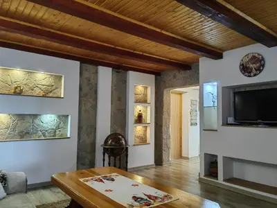 a living room with a table and a flat screen tv at 