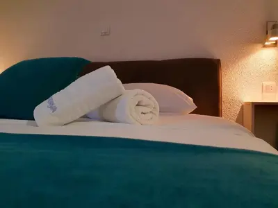 a roll of toilet paper sitting on a bed at Wellness&Spa Hotel Astorya in Banja Luka