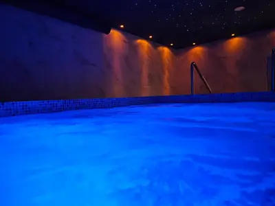 a swimming pool with blue lights on the wall at Wellness&Spa Hotel Astorya in Banja Luka