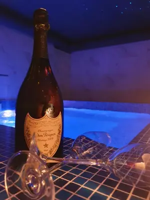 a bottle of wine sitting on a table with glasses at Wellness&Spa Hotel Astorya in Banja Luka