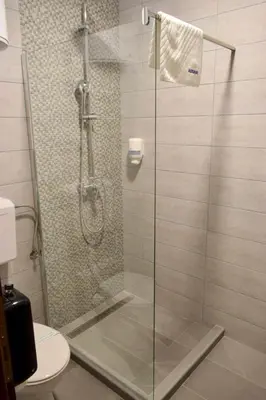 a shower with a glass door in a bathroom at Wellness&Spa Hotel Astorya in Banja Luka