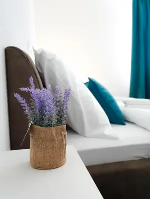 a vase with purple flowers sitting on a table at Wellness&Spa Hotel Astorya in Banja Luka
