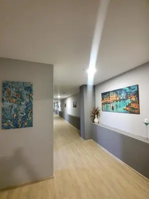 a hallway of an art gallery with paintings on the walls at Wellness&Spa Hotel Astorya in Banja Luka