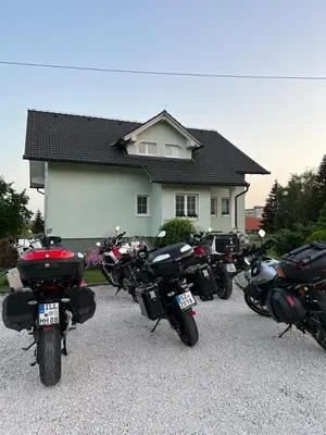a row of motorcycles parked in front of a house at Apartman M. Rados in Kupres