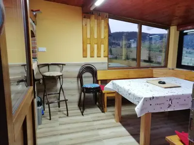 a room with a table and chairs and a window at Apartmani ( VILA ) Vucko in Vlasic