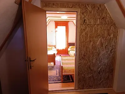 a door leading into a room with a bedroom at Apartmani ( VILA ) Vucko in Vlasic