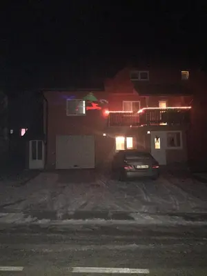 a car parked in front of a house at night at Apartman Vesna in Kupres