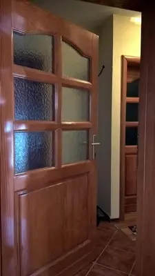 a wooden door with glass panels in a room at Apartman Vesna in Kupres