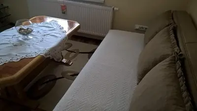 a bedroom with a bed and a table with a tableasonable at Apartman Vesna in Kupres