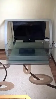 a glass table with a flat screen tv on top at Apartman Vesna in Kupres