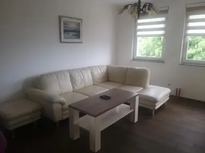 a living room with a couch and a coffee table at Brilliant Apartman in Bihać