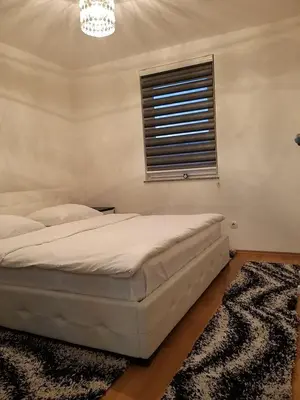 a bedroom with a bed and a window at Brilliant Apartman in Bihać