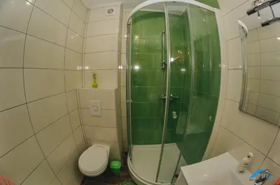 a bathroom with a shower and a toilet and a sink at Brilliant Apartman in Bihać
