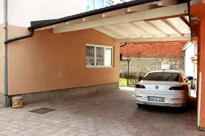 a car parked in a parking lot next to a building at Apartman River Una in Bihać