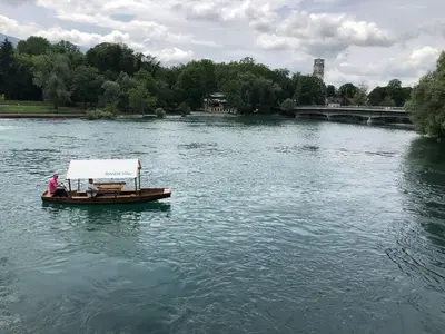 a small boat in the middle of a river at Apartman River Una in Bihać