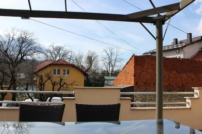 a table and chairs on top of a balcony at Apartman River Una in Bihać
