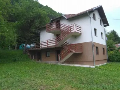 a house with red stairs on the side of it at Hostel Topić in Banja Luka