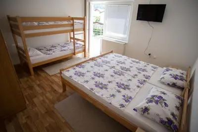 a bedroom with two bunk beds and a window at Hostel Larisa in Banja Luka
