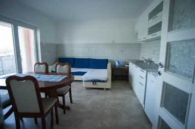 a kitchen with a table and a couch in a room at Hostel Larisa in Banja Luka