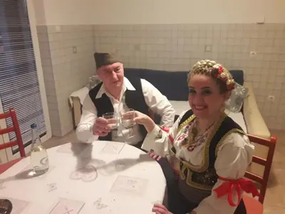a man and a woman sitting at a table at Hostel Larisa in Banja Luka
