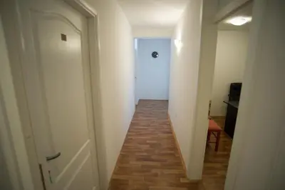 a hallway with a white door and a stairway at Hostel Larisa in Banja Luka