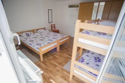a small room with two bunk beds and a bed at Hostel Larisa in Banja Luka