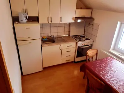a small kitchen with a refrigerator and a stove at Jelena in Kupres