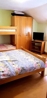 a bedroom with two bunk beds and a flat screen tv at Jelena in Kupres
