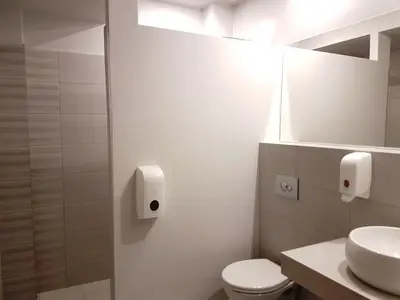 a bathroom with a toilet and a sink and a mirror at Hotel SAX Gračanica in Gračanica