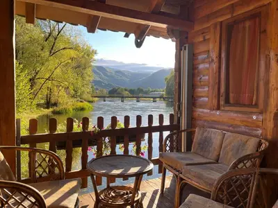 a porch with a chair and a view of a river at Vacation Home Pliva in Šipovo