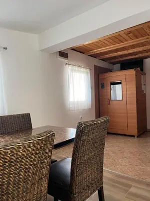 a room with a table and chairs and a door at Vacation Home Pliva in Šipovo
