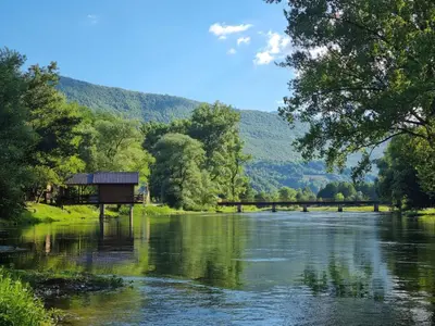 a view of a river with a bridge in the background at Vacation Home Pliva in Šipovo