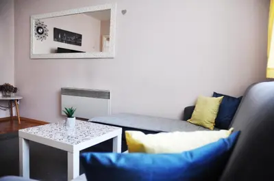 a living room with a couch and a table at Apartman Visoko in Visoko