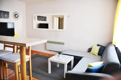 a living room with a couch and a table at Apartman Visoko in Visoko