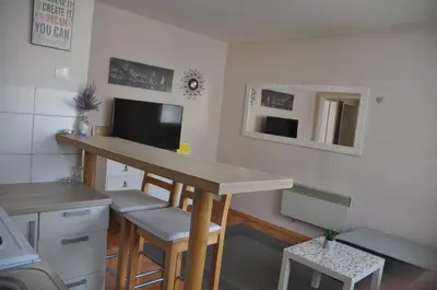 a kitchen with a counter and a table in a room at Apartman Visoko in Visoko
