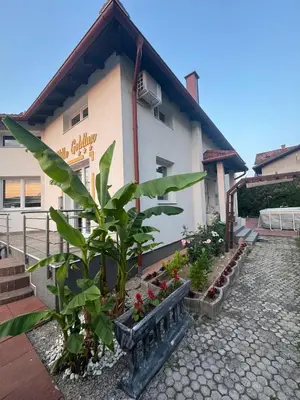 a building with a bunch of plants in front of it at Villa Goldlux in Bihać