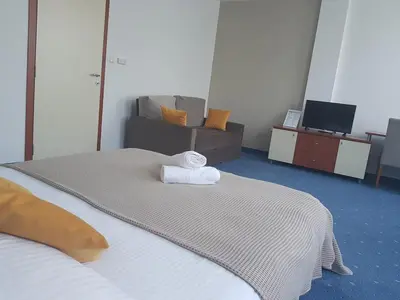 a room with a bed with a towel on it at Hotel CITY in Prnjavor
