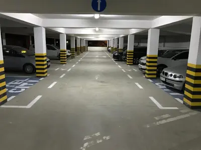 an empty parking garage with cars parked in it at Hotel CITY in Prnjavor