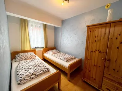 a bedroom with two beds and a cabinet at Apartment Love in Vlasic